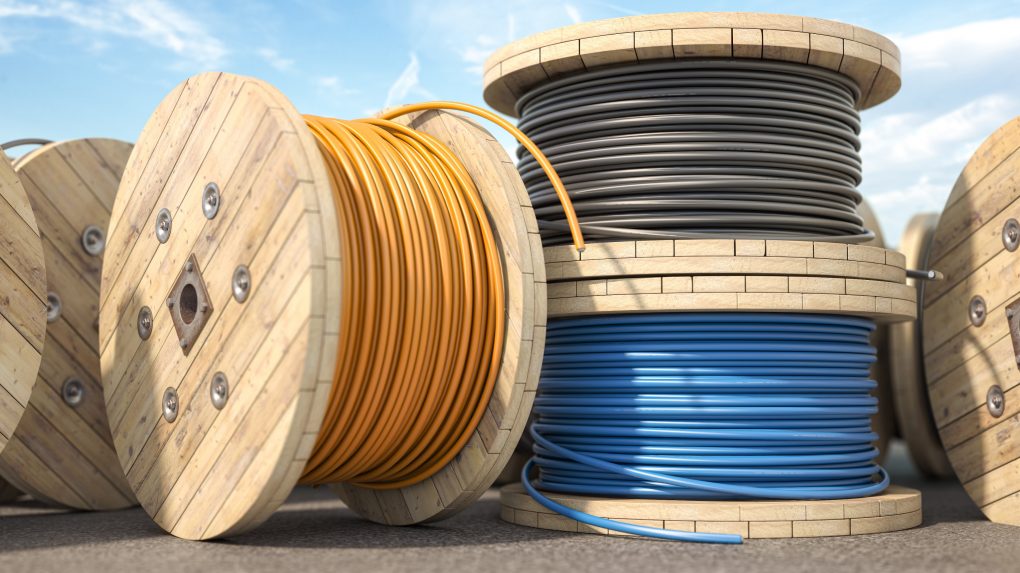 Wire electric cable of different colors on wooden coil or spool